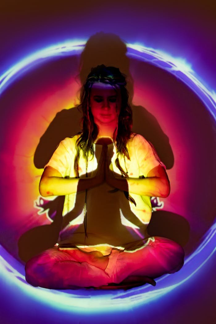 A woman meditating within a radiant aura, evoking spirituality and balance.